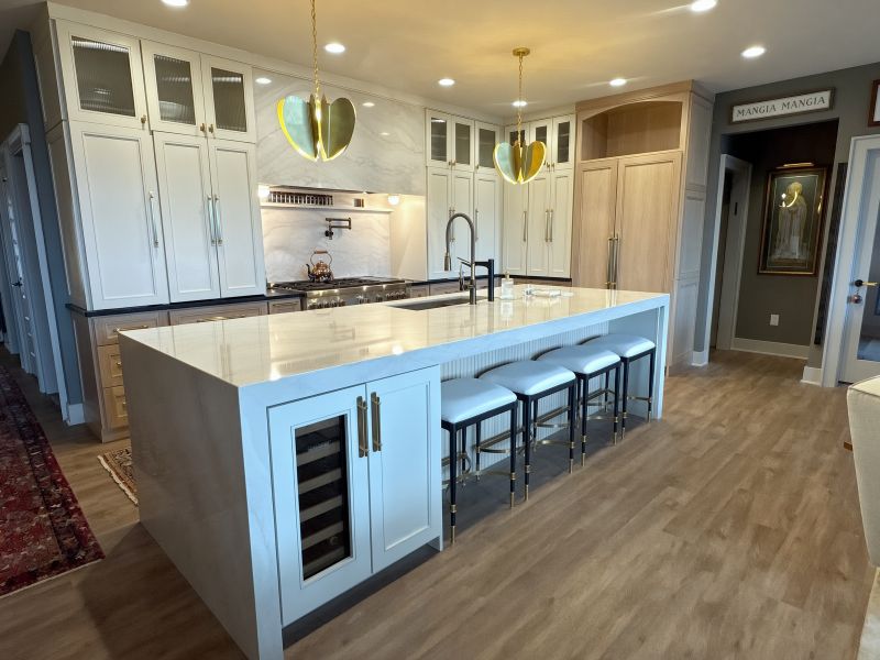 Cambria Everleigh Warm quartz waterfall island with brass pendants in a warm custom kitchen